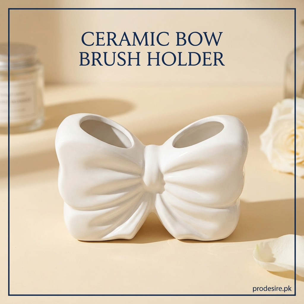 White ceramic bow brush holder with two open storage compartments on a cream vanity