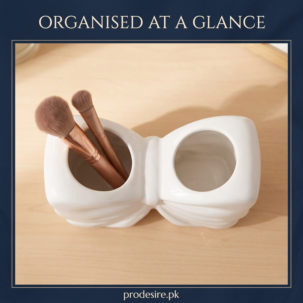 Overhead view of white bow organiser with makeup brushes in one compartment