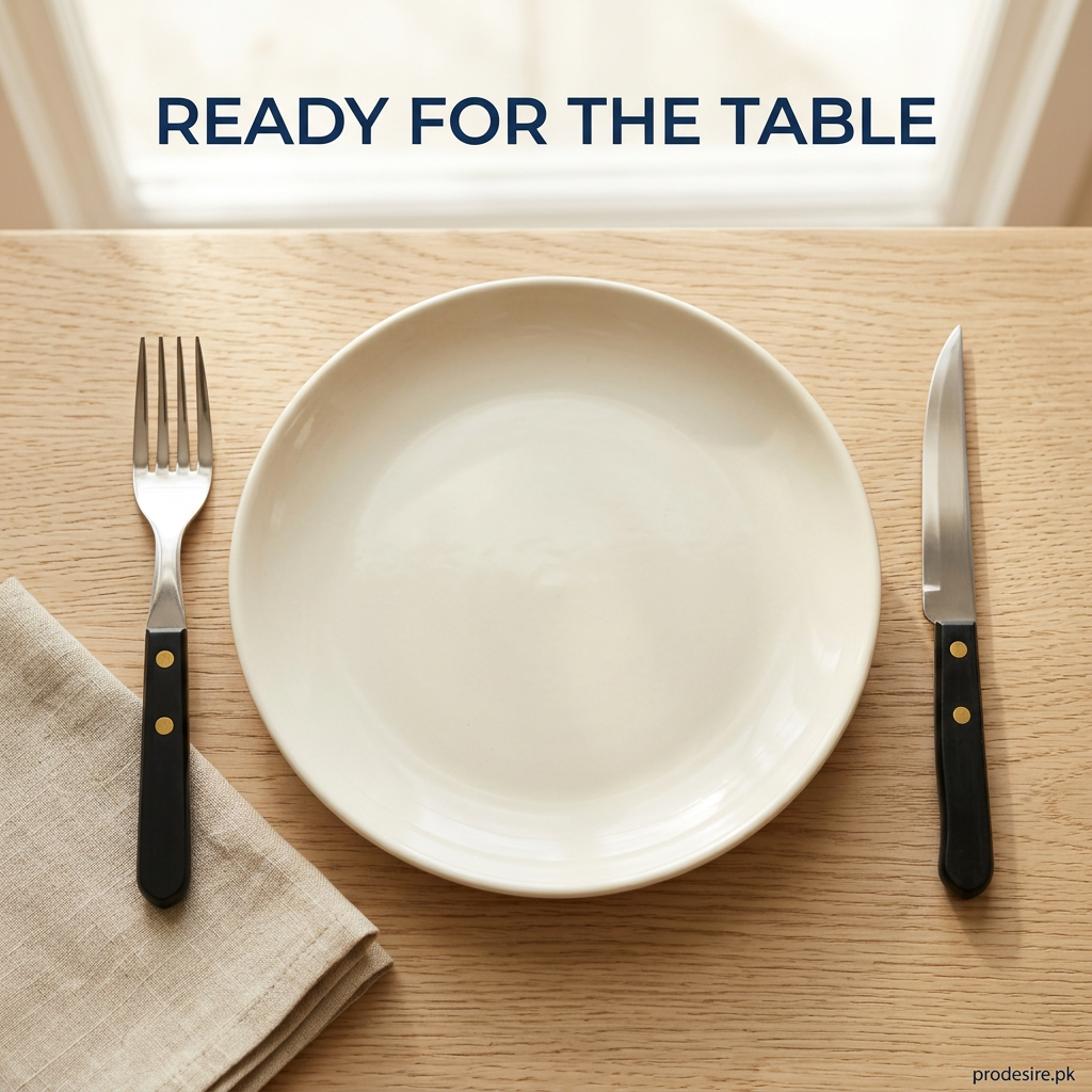 Overhead place setting with a black-handled fork and knife beside an ivory plate